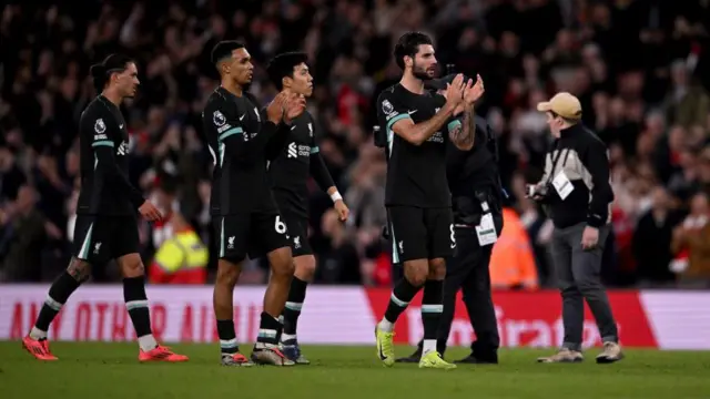 Dominik Szoboszlai and Trent Alexander-Arnold of Liverpool showing his appreciation to the fans at the end of the Premier League match between Arsenal FC and Liverpool FC at Emirates Stadium