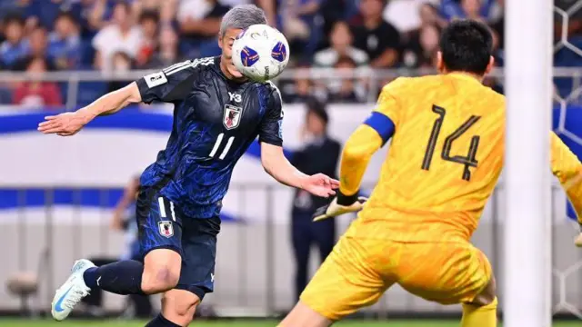 Celtic's Daizen Maeda heads home Japan's sixth goal in the rout of China