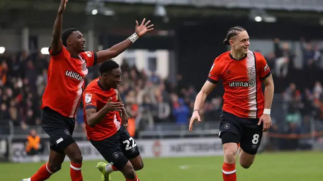 Luton Town players celebrate with Theo Aasgaard following his goal against Bristol City earlier this month