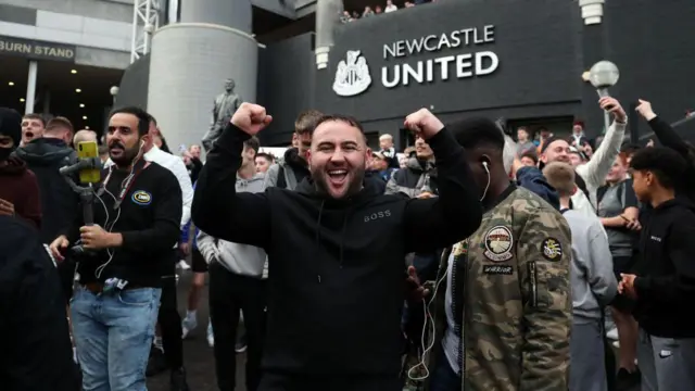 Newcastle fans celebrate the club's takeover