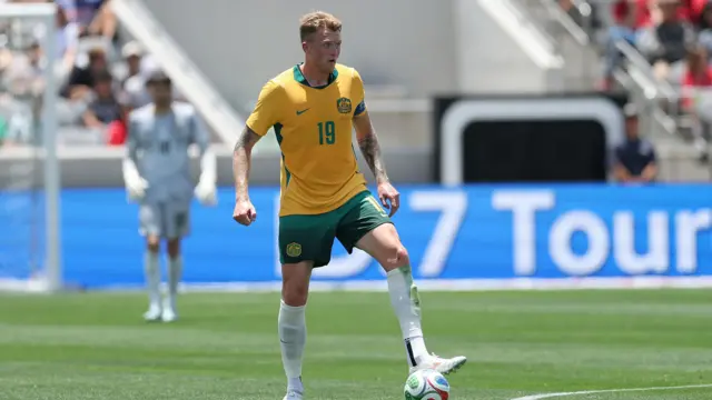 Harry Souttar, wearing Australia's yellow and green home kit, in action against Switzerland on 6 June