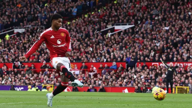 Manchester United's English striker #10 Marcus Rashford shoots to score the opening goal of the English Premier League football match between Manchester United and Everton at Old Trafford in Manchester, north west England, on December 1, 2024