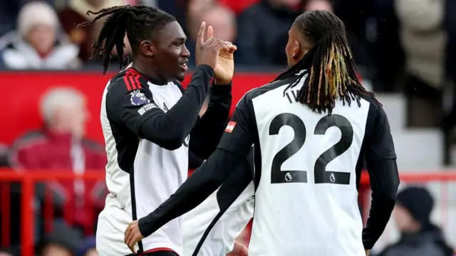 Calvin Bassey of Fulham celebrates scoring his team's first goal with teammate Alex Iwobi