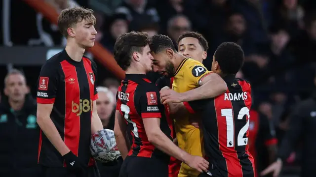 Matheus Cunha of Wolverhampton Wanderers clashes with Milos Kerkez of AFC Bournemouth.