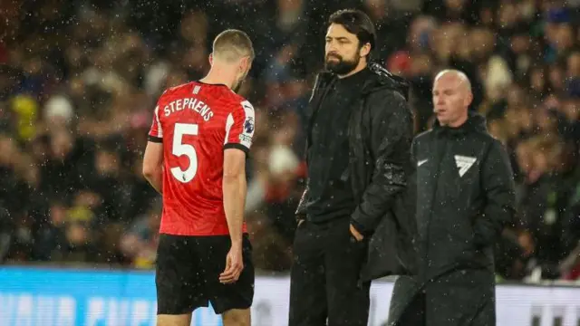 Jack Stephens walks past Russell Martin after being sent off