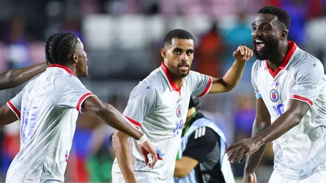 Jean-Ricner Bellegarde #10, Yassin Fortuné #19 and Frantzdy Pierrot #20 of Haiti celebrate after defeating New Zealand in the international friendly 