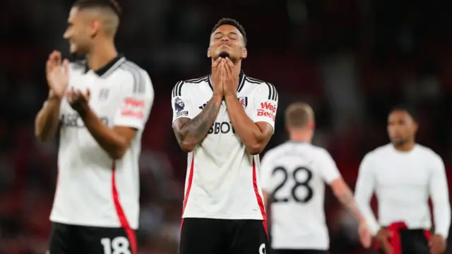 Fulham players look dejected after defeat at Manchester United