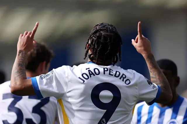 Joao Pedro of Brighton points to the sky in celebration