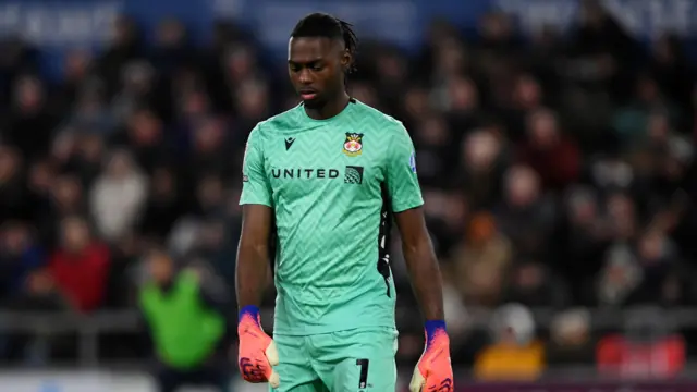 Arthur Okonkwo staring at the ground
