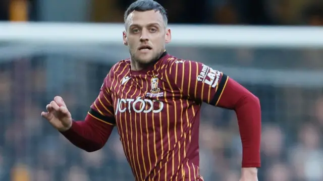 Aden Baldwin in action for Bradford City in their claret and amber home shirt