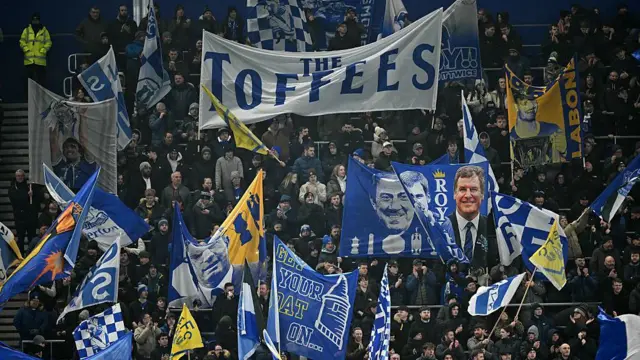 General view of Everton fans holding up banners in the stands