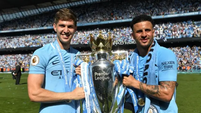 John Stones and Kyle Walker hold up the Premier League trophy