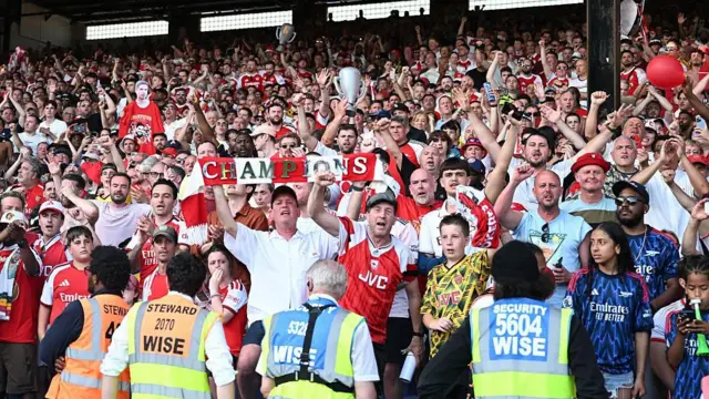 Arsenal fans celebrating in the away end at Selhurst Park