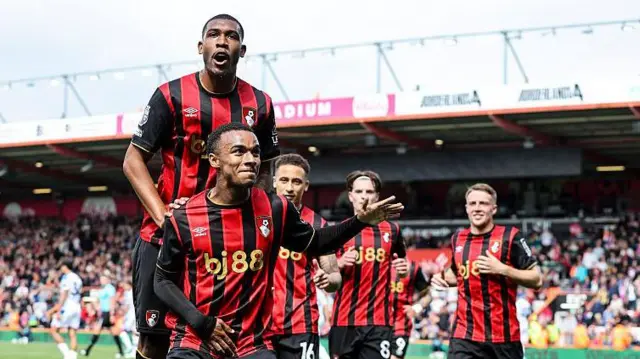 Rayan, Eli Junior Kroupi and Alex Scott celebrate a Bournemouth goal at Vitality Stadium