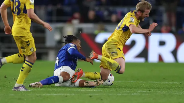 Cardiff's Gabriel Osho slides in on Ewan Henderson to earn a red card