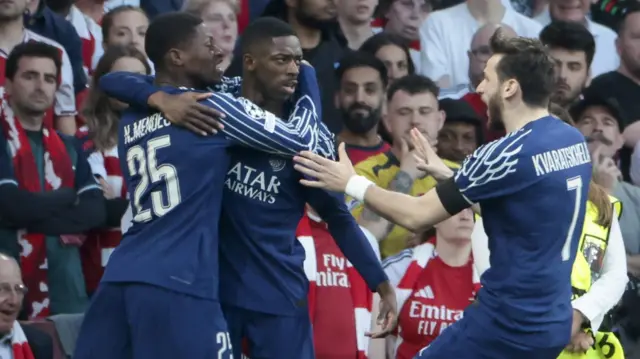 PSG players celebrate a goal against Arsenal
