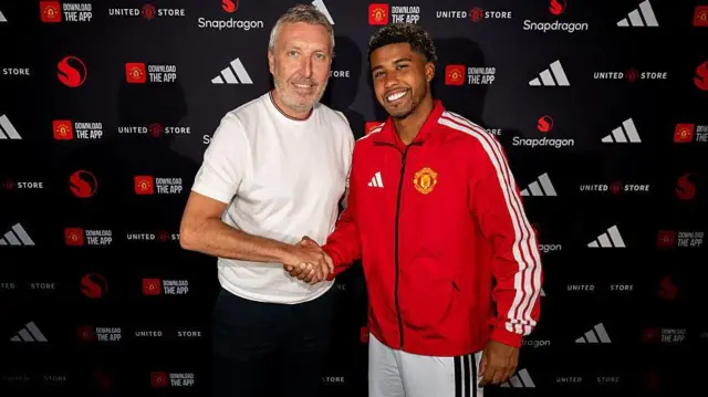 Andrey Santos poses with director of football Jason Wilcox after signing for Manchester United