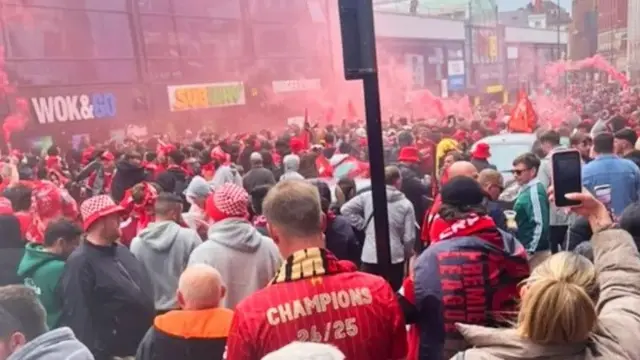 Crowds of Liverpool fans streaming past Liverpool's Central station heading to the waterfront
