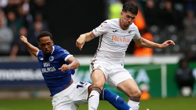 Swansea City right-back Josh Key (R) is challenged by Cardiff City winger Chris Willock