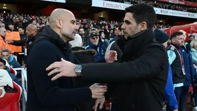 Pep Guardiola and Mikel Arteta embrace