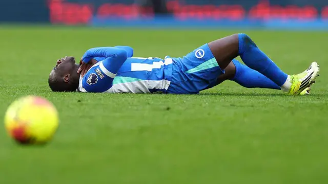Yankuba Minteh of Brighton & Hove Albion goes down injured 