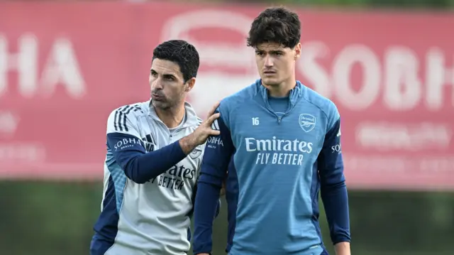 Arsenal manager Mikel Arteta talks to Christian Norgaard during a training session