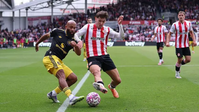 Bryan Mbeumo of Manchester United is tackled by Aaron Hickey of Brentford