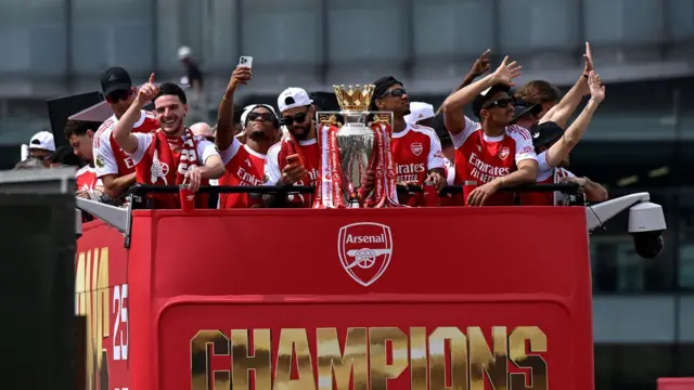 Declan Rice, Jurrien Timber, David Raya, Gabriel and William Saliba of Arsenal celebrate with the Premier League Trophy on an open top bus