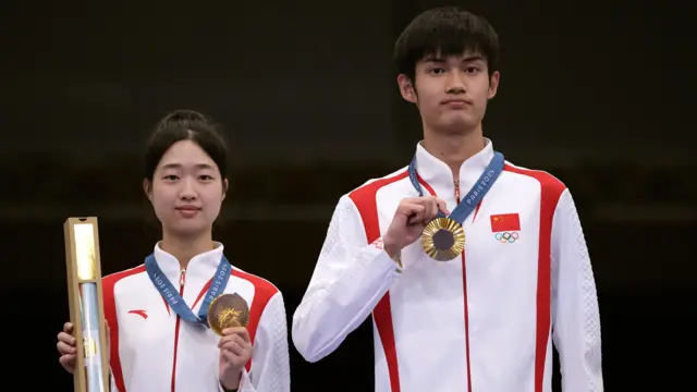 China's Huang Yuting and Sheng Lihao win first gold medal at 2024 Paris Olympics with victory in the mixed team 10m air rifle