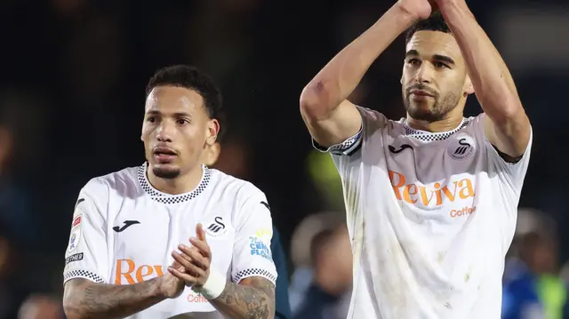 Ronald and Ben Cabango clapping at the end of match.