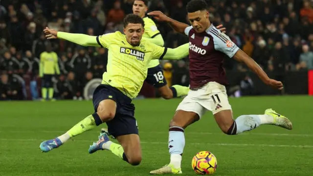 Nathan Wood challenges Ollie Watkins