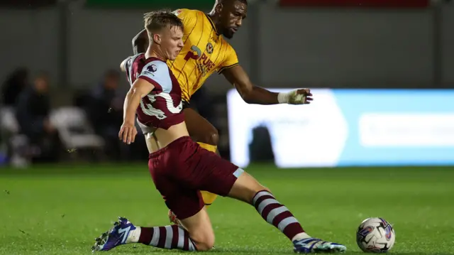 Kaelan Casey playing for West Ham tackles Omar Bogle of Newport County in a Carabao Cup tie