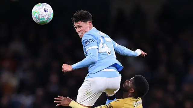 Phil Foden of Manchester City wins a header over Jefferson Lerma of Crystal Palace