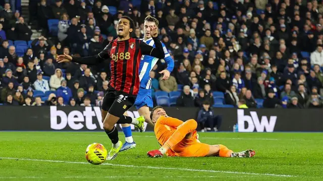 Bart Verbruggen of Brighton concedes a penalty against Amine Adli of Bournemouth. 