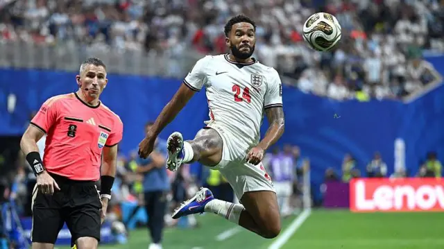 Reece James stretches to control a high ball