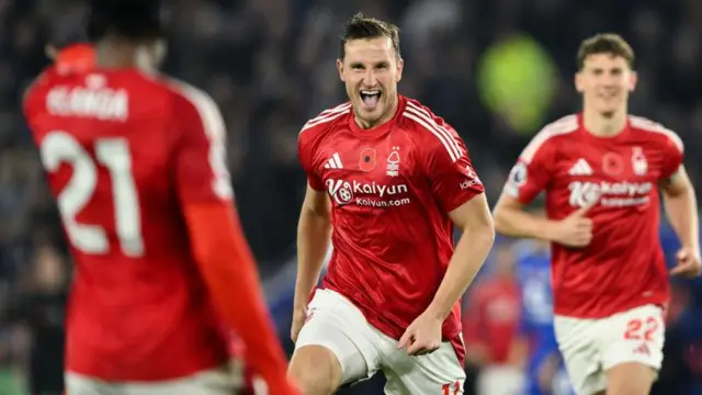 Chris Wood runs to celebrate with Nottingham Forest team-mates after scoring against Leicester