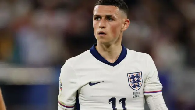 Phil Foden looks on while playing for England