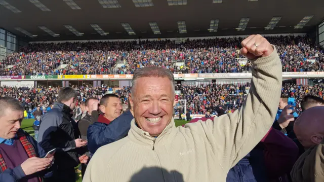 Burnley supporter on pitch celebrating at Turf Moor