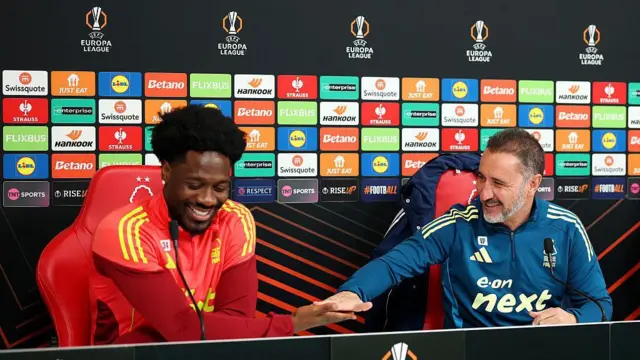 Ola Aina and Vitor Pereira interact during a Nottingham Forest Press Conference
