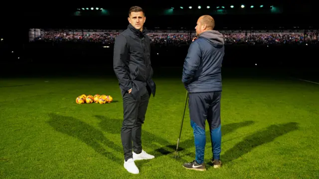 Portsmouth head coach John Mousinho looks around a dark Fratton Park with floodlights having gone out