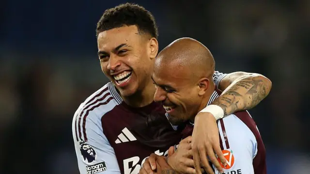 Morgan Rogers with his arms around Malen smiling together during the last match Villa faced at the American Express Stadium