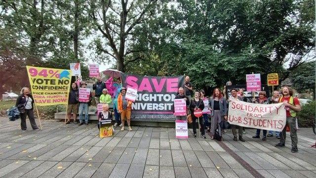 Staff and students protesting with banners and placards 