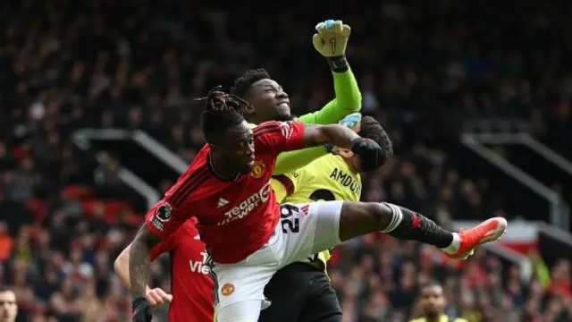 Andre Onana challenges for a ball in the box