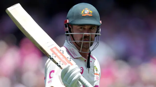 Travis Head acknowledges the crowd after scoring a century in Sydney