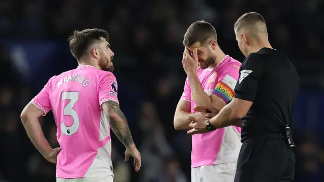 Southampton players look disappointed as referee explains disallowed goal