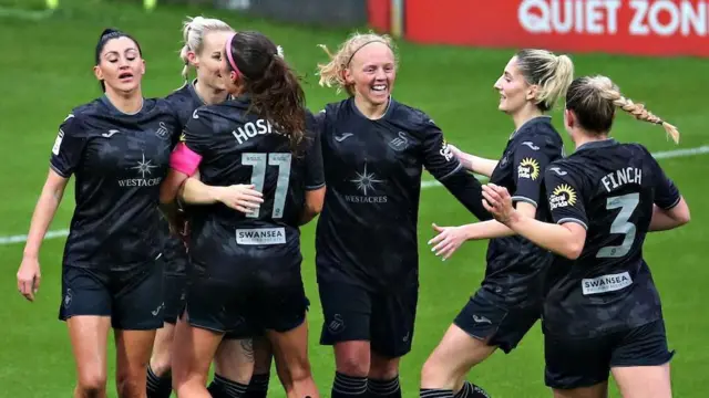 Swansea players celebrate during their win at Wrexham