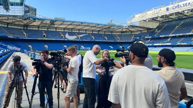 Photographers prepare for Xabi Alonso to pose for pictures near the pitch at Stamford Bridge