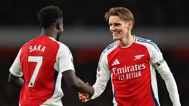 Bukayo Saka and Martin Odegaard of Arsenal celebrate after Thomas Partey of Arsenal (not pictured) scores his team's second goal during the Premier League match between Arsenal FC and Nottingham Forest FC at Emirates Stadium