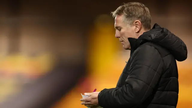 Wrexham boss Phil Parkinson writes notes on the touchline during the midweek EFL Trophy game at Port Vale