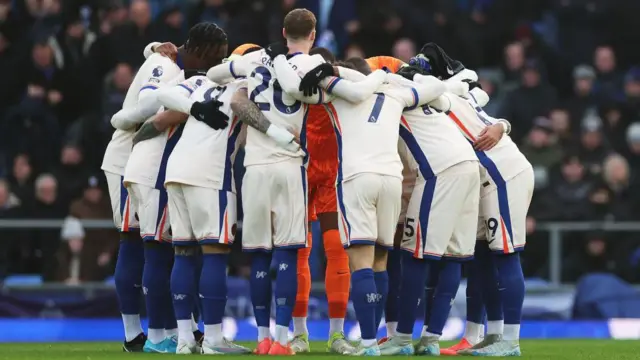 Chelsea team huddle before kick-off